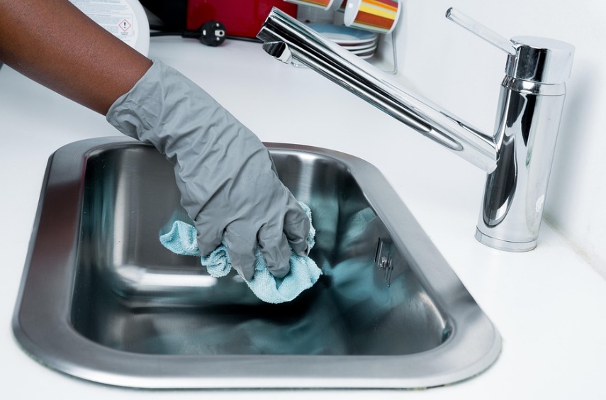 Maid cleaning sink in Medellin