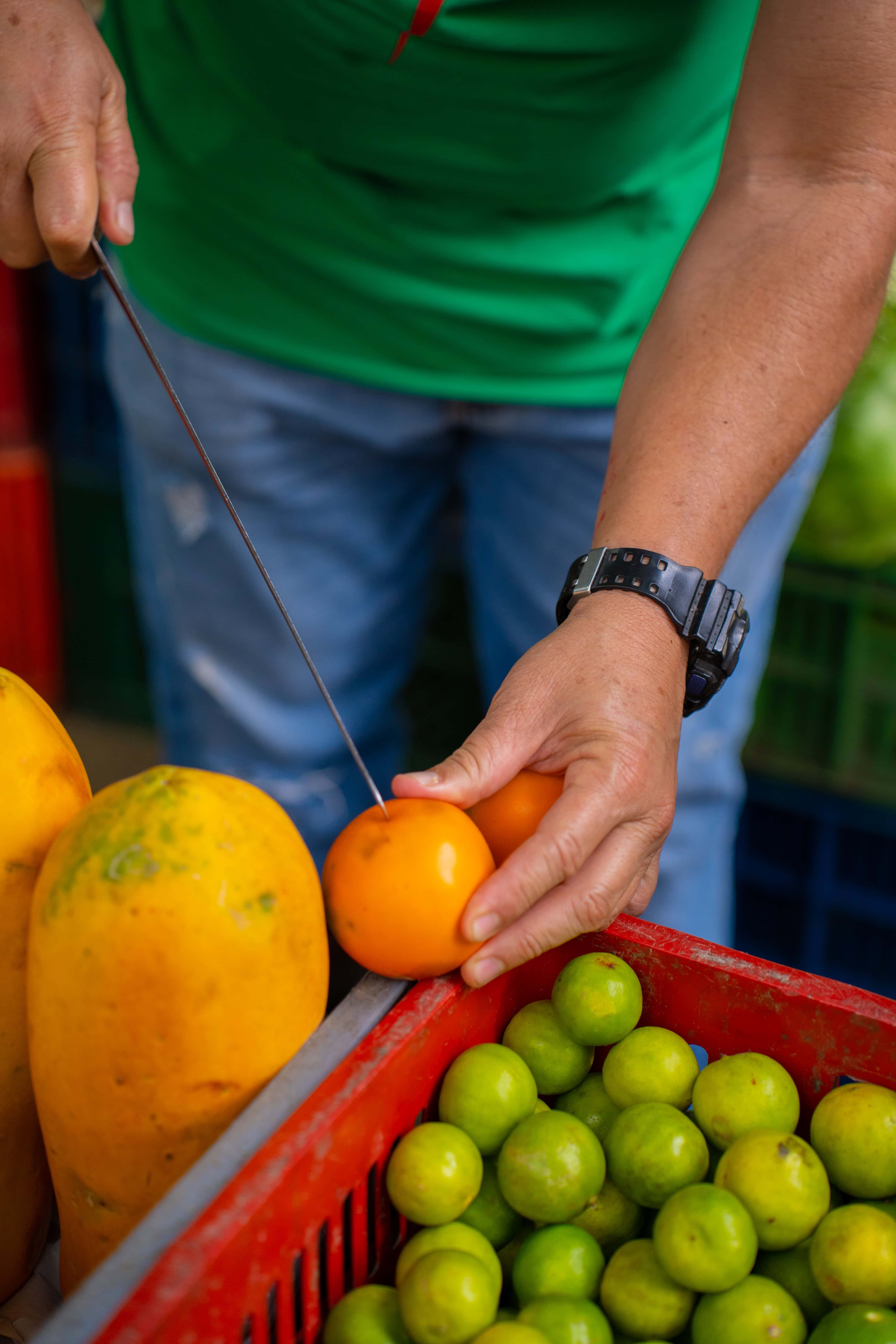 Tropical fruits including papaya and limes at a Medellín fruit stall
